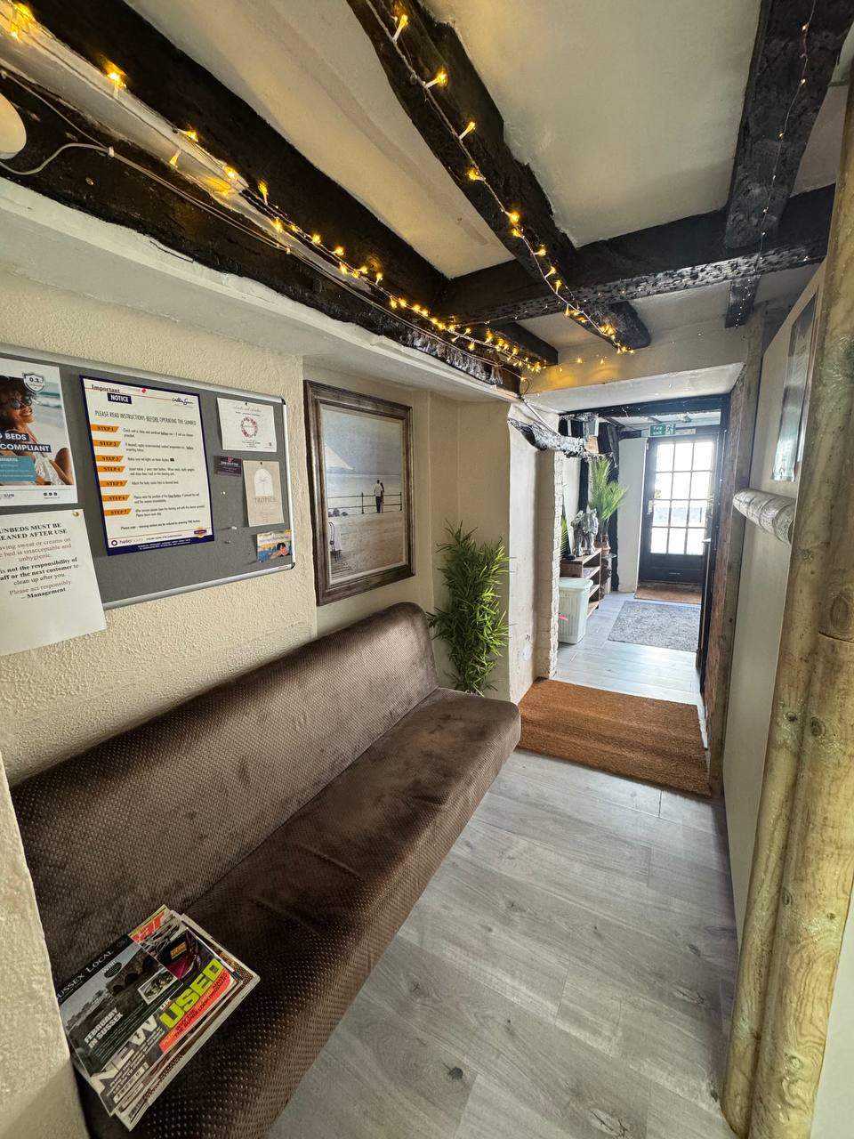 Midhurst Tropics salon interior with warm fairy lights and wooden beams