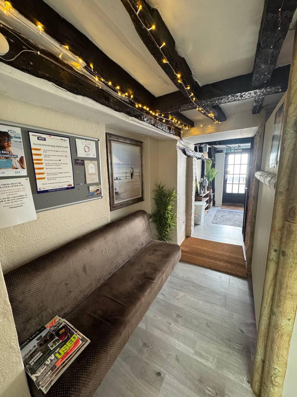 Midhurst Tropics salon interior with warm fairy lights and wooden beams